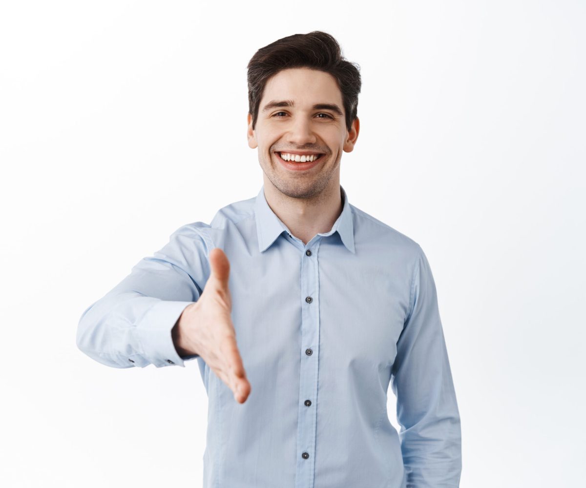 Nice to meet you. Handsome businessman stretch out hand for handshake, greeting business partner, corporate welcome, standing over white background.